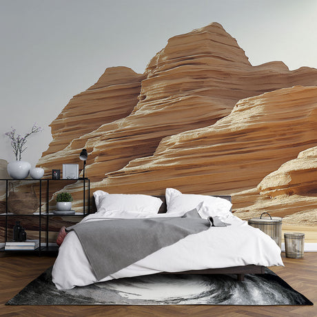 Desert rock formation wallpaper creating a stunning accent wall in a modern minimalist living room with earth-toned furniture