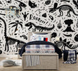Black and white dinosaur skeleton wallpaper creating an educational atmosphere in a modern playroom