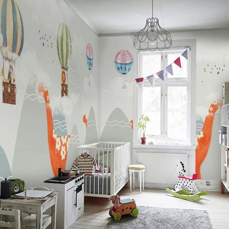Dinosaur nursery wallpaper with hot air balloons creates a magical atmosphere in a modern nursery with white furniture