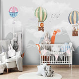 Mountain nursery mural with floating balloons and dinosaurs transforms a playroom into an adventure zone