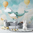 Whale and balloon nursery wallpaper in a bright modern nursery with white furniture