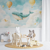 Playroom wall with whimsical whale and balloon wallpaper next to reading nook