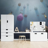 Dreamy blue wallpaper with magical floating fruits in a teen's study room