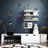 Magical fruit mural creating depth in a reading nook with blue tones