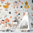 Farm animals wallpaper in a bright nursery with white furniture, showing playful pastel animals above the crib
