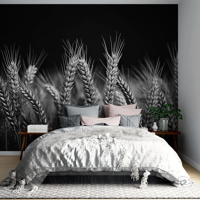 Black and white wheat field wallpaper creating dramatic impact in a modern dining room with minimal furniture