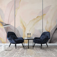 Pink and gold feather wallpaper mural creating an elegant atmosphere in a modern bedroom with soft lighting