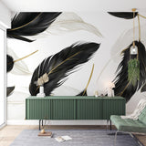 Black and gold feather wallpaper mural styled in a modern living room with grey sofa and gold accents