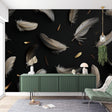 Black and gold feather wallpaper mural creating an elegant atmosphere in a modern living room with tall windows