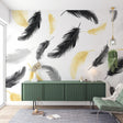 Black and gold feather wallpaper mural in a modern living room, creating an elegant floating effect against white walls