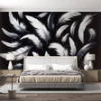 Black and white feather wallpaper mural in modern minimalist bedroom, creating an elegant floating effect above the bed