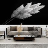 Black and white pampas grass wallpaper creating dramatic contrast in a modern living room with minimalist furniture