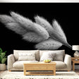 Black and white pampas grass wallpaper creating depth in a modern living room with minimal furniture