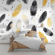 Black and gold feather wallpaper in modern dining room with soft lighting highlighting metallic accents