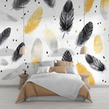 Black and gold feather wallpaper in modern dining room with soft lighting highlighting metallic accents
