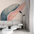 Modern feather wallpaper with pink and blue leaves shown in a bright living room setting, creating a calm atmosphere