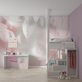 Delicate feather wall mural bringing elegance to a pink dressing room with gold accents