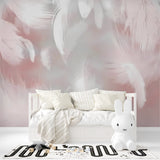 Soft pink feather pattern adding grace to a nursery with white furniture