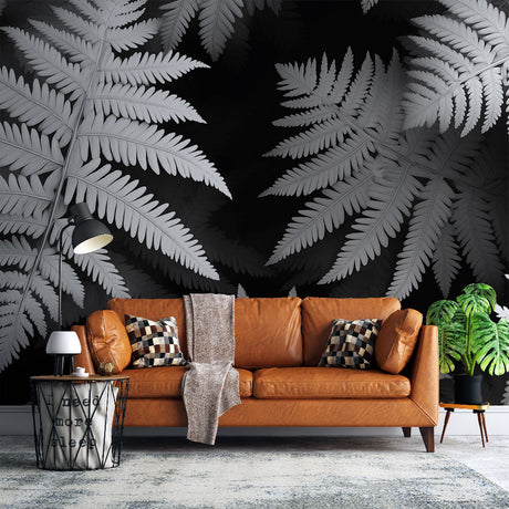 Black and white fern wallpaper creating dramatic contrast in a modern living room with minimalist furniture