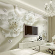 White 3D floral wallpaper creating depth in a modern living room with natural light highlighting the textured blooms