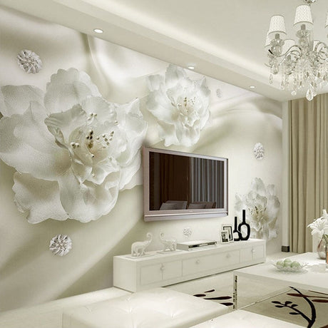 White 3D floral wallpaper creating depth in a modern living room with natural light highlighting the textured blooms
