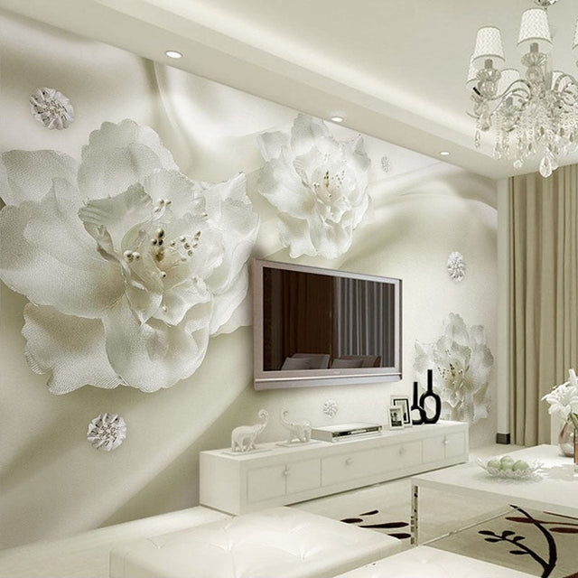 White 3D floral wallpaper creating depth in a modern living room with natural light highlighting the textured blooms