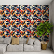Art Deco floral wallpaper in navy and orange creating a stunning focal point in a modern living room with mid-century furniture