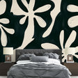 Black and white floral wallpaper mural styled in modern dining room with minimal furniture and natural light