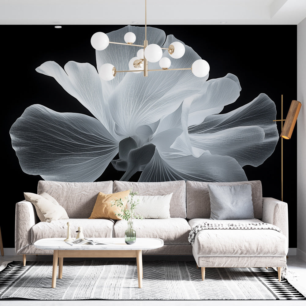 Black and white floral wallpaper mural creating dramatic contrast in a modern living room with minimal furniture