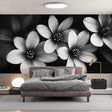 Black and white floral wallpaper creating dramatic impact in modern living room with minimalist furniture