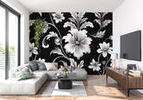 Black and white floral wallpaper in modern living room setting with minimal furniture