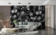 Black and white floral wallpaper adding drama to a modern living room with grey sofa and natural light