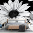 Black and white daisy wallpaper mural in modern living room setting, creating dramatic contrast against neutral furniture