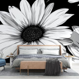Black and white daisy wallpaper mural in modern living room setting, creating dramatic contrast against neutral furniture