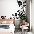 Black and white floral wallpaper creating dramatic impact in a modern living room with natural light