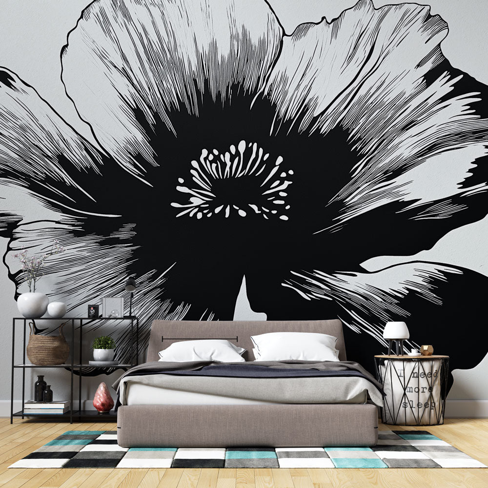 Black and white floral wallpaper creating dramatic contrast in a modern living room with minimal furniture