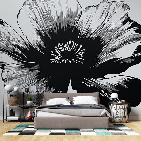 Black and white floral wallpaper creating dramatic contrast in a modern living room with minimal furniture