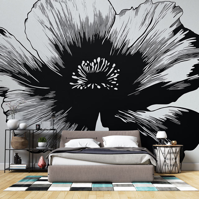 Black and white floral wallpaper creating dramatic contrast in a modern living room with minimal furniture