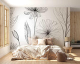 Black and white floral line art wallpaper creating a stunning focal point in a modern living room with minimal furniture