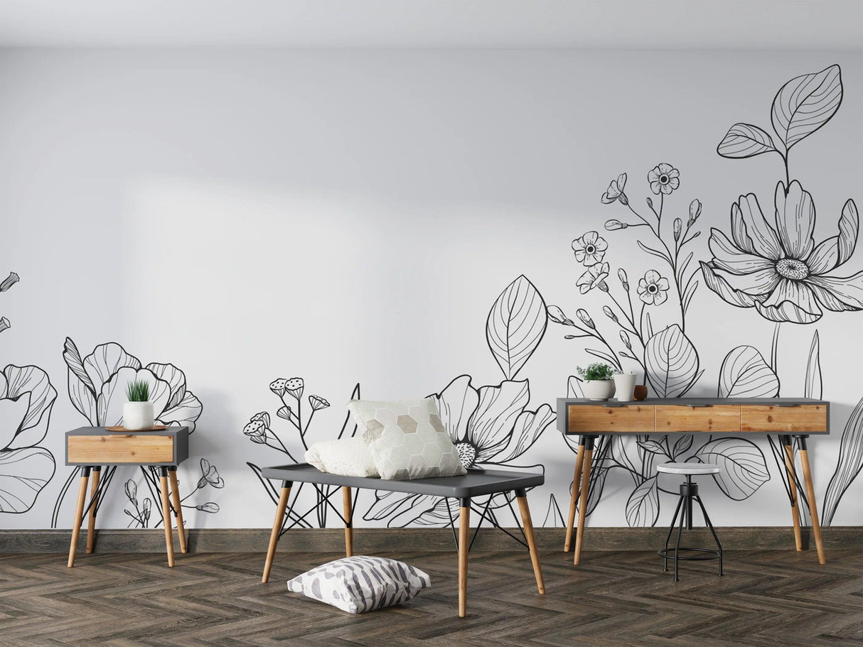 Modern black and white botanical line art wallpaper creating a sophisticated backdrop in a minimalist living room