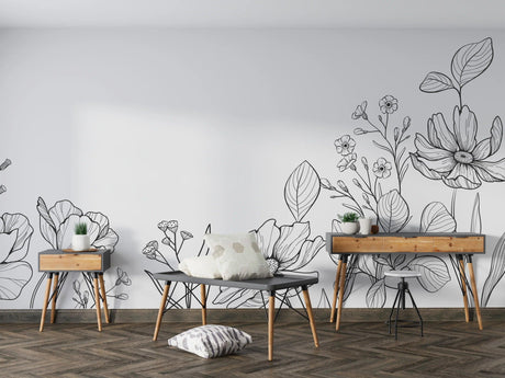 Modern black and white botanical line art wallpaper creating a sophisticated backdrop in a minimalist living room