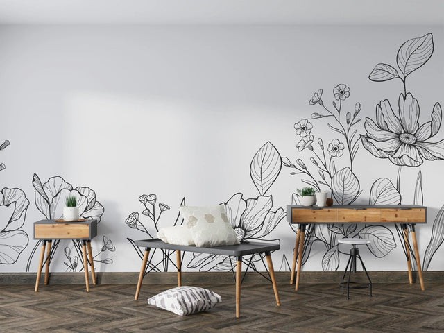 Modern black and white botanical line art wallpaper creating a sophisticated backdrop in a minimalist living room