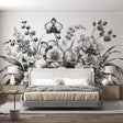 Black and white orchid wallpaper mural creating an elegant statement wall in a modern dining room with minimalist furniture