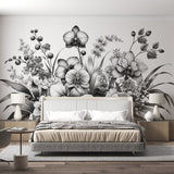 Black and white orchid wallpaper mural creating an elegant statement wall in a modern dining room with minimalist furniture
