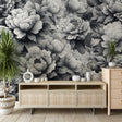 Black and white peony wallpaper creating a stunning focal point in a modern living room with minimal furniture