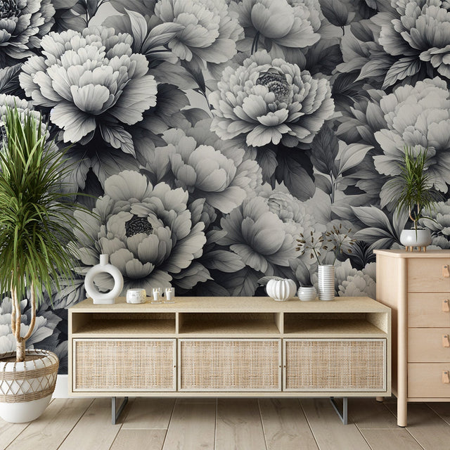 Black and white peony wallpaper creating a stunning focal point in a modern living room with minimal furniture