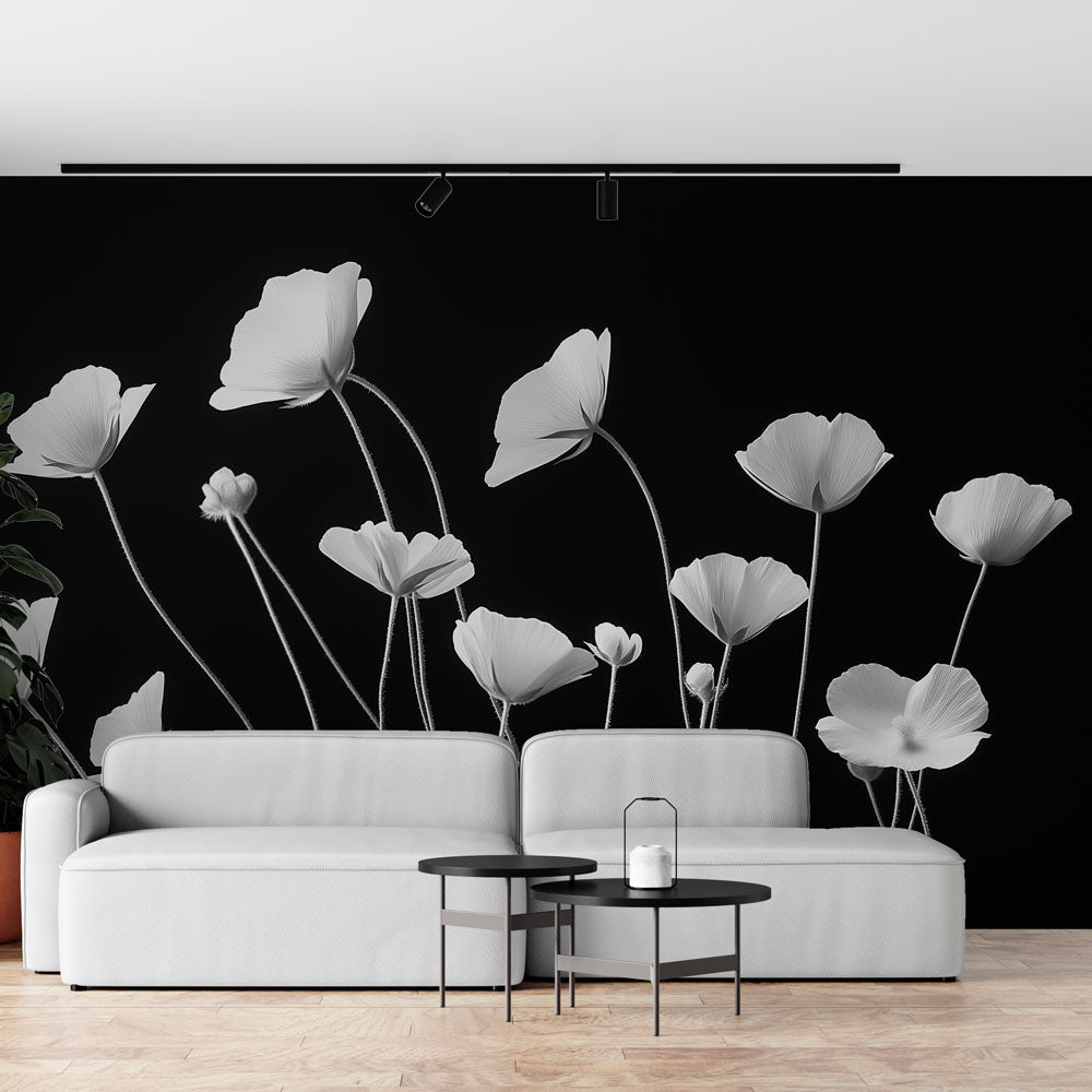 Black and white poppy wallpaper mural creating dramatic impact in a modern living room with minimal furniture