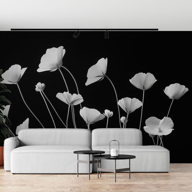 Black and white poppy wallpaper mural creating dramatic impact in a modern living room with minimal furniture
