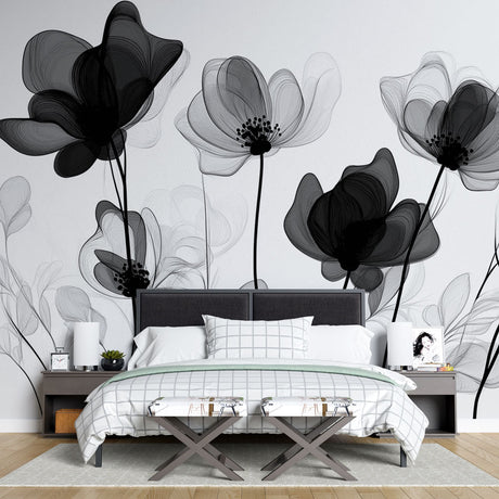 Black and white floral wallpaper mural creating drama in a modern living room with high ceilings and minimal furniture