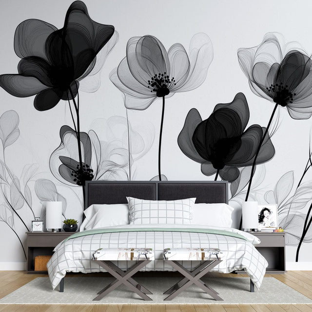 Black and white floral wallpaper mural creating drama in a modern living room with high ceilings and minimal furniture